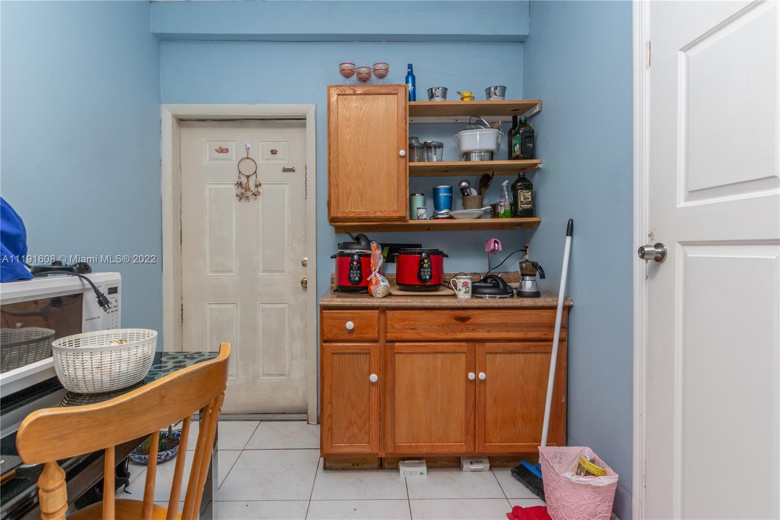 13560 Southwest 2nd Street Miami, FL 33184 - Photo 49 of 50 a room with a refrigerator and a shelf