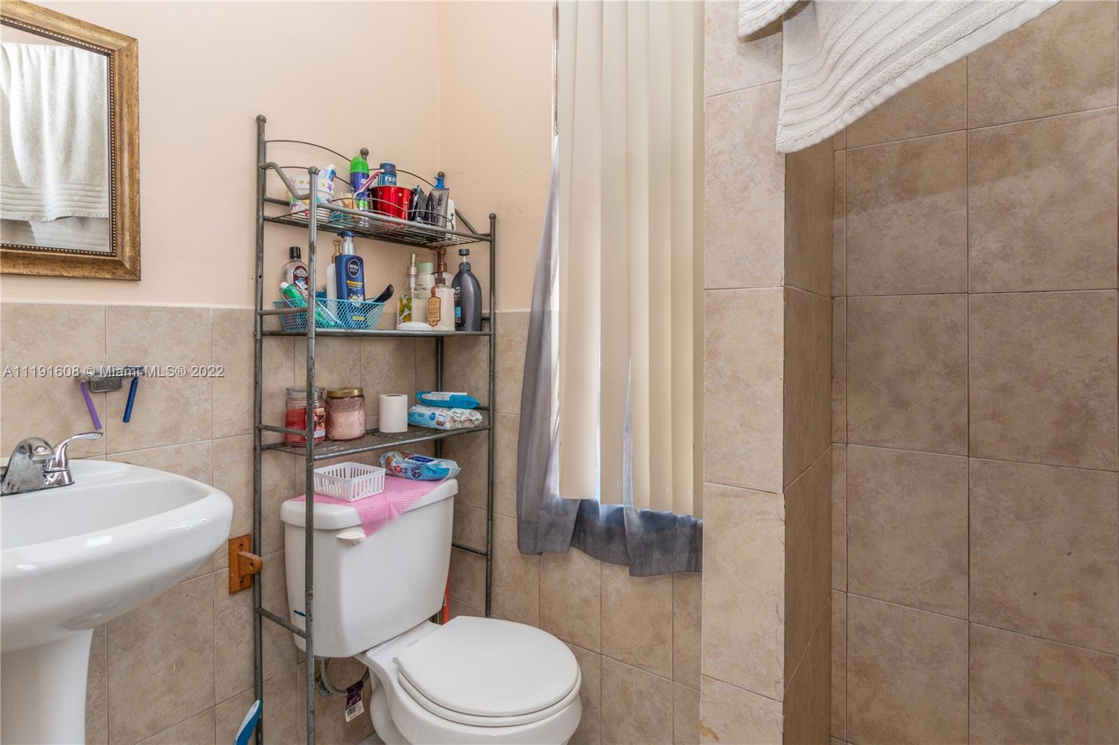 13560 Southwest 2nd Street Miami, FL 33184 - Photo 50 of 50 a white toilet sitting next to a bathroom sink