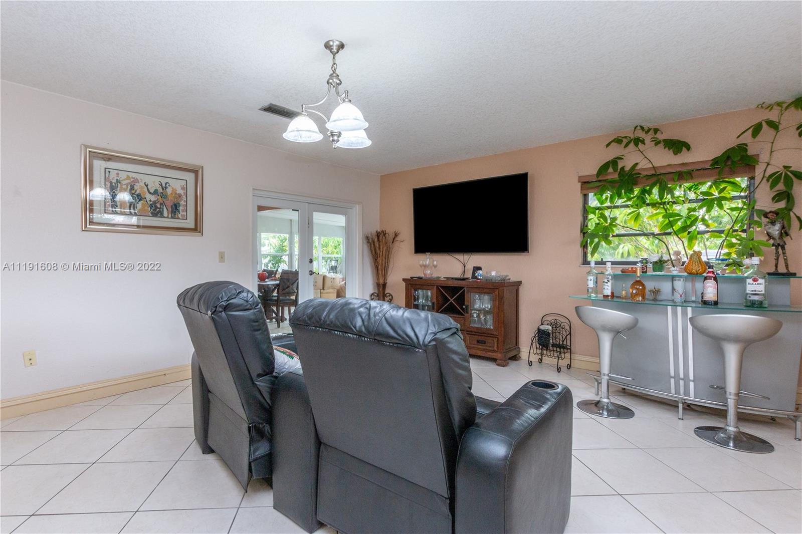 13560 Southwest 2nd Street Miami, FL 33184 - Photo 8 of 50 a view of a livingroom with furniture and a flat screen tv