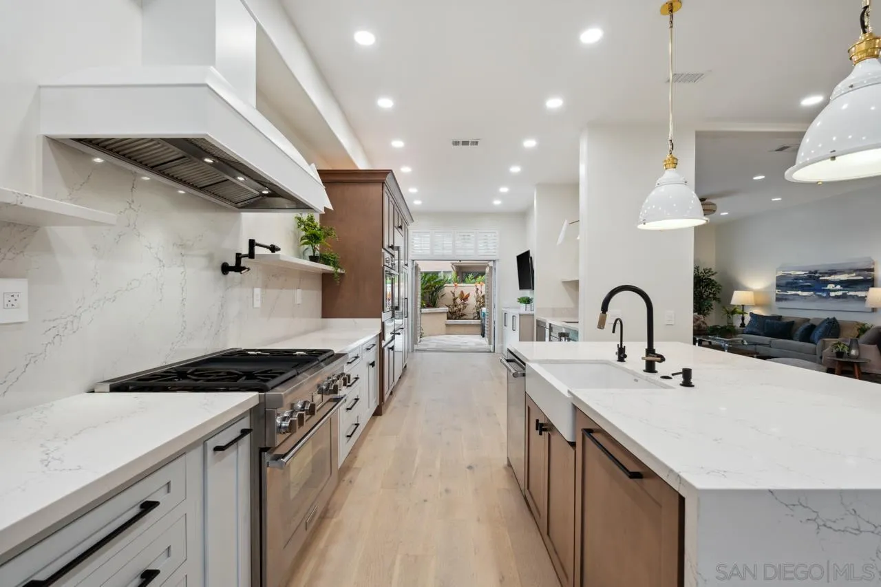 15345 Via Simpatico Rancho Santa Fe, CA 92091 - Photo 15 of 75 a kitchen with counter top space a sink stainless steel appliances and cabinets