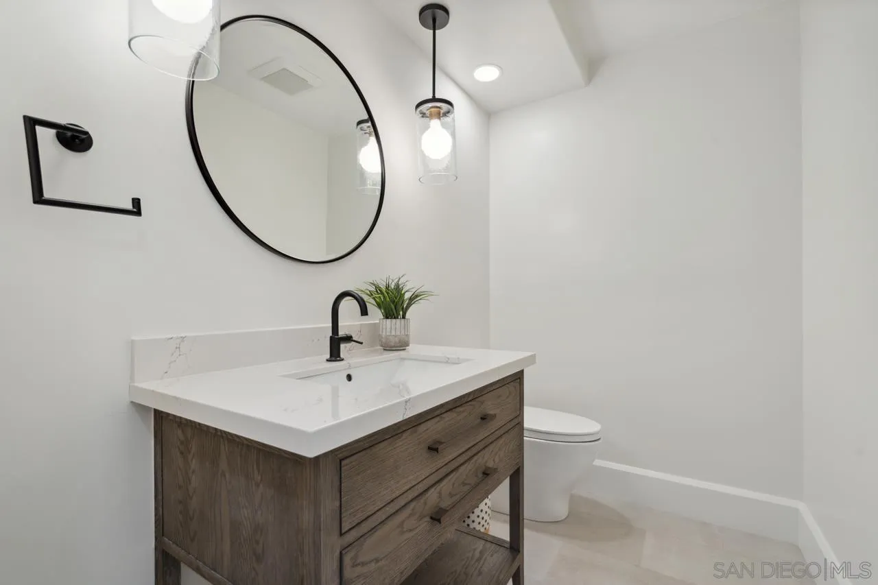 15345 Via Simpatico Rancho Santa Fe, CA 92091 - Photo 40 of 75 a bathroom with a sink a mirror and a toilet