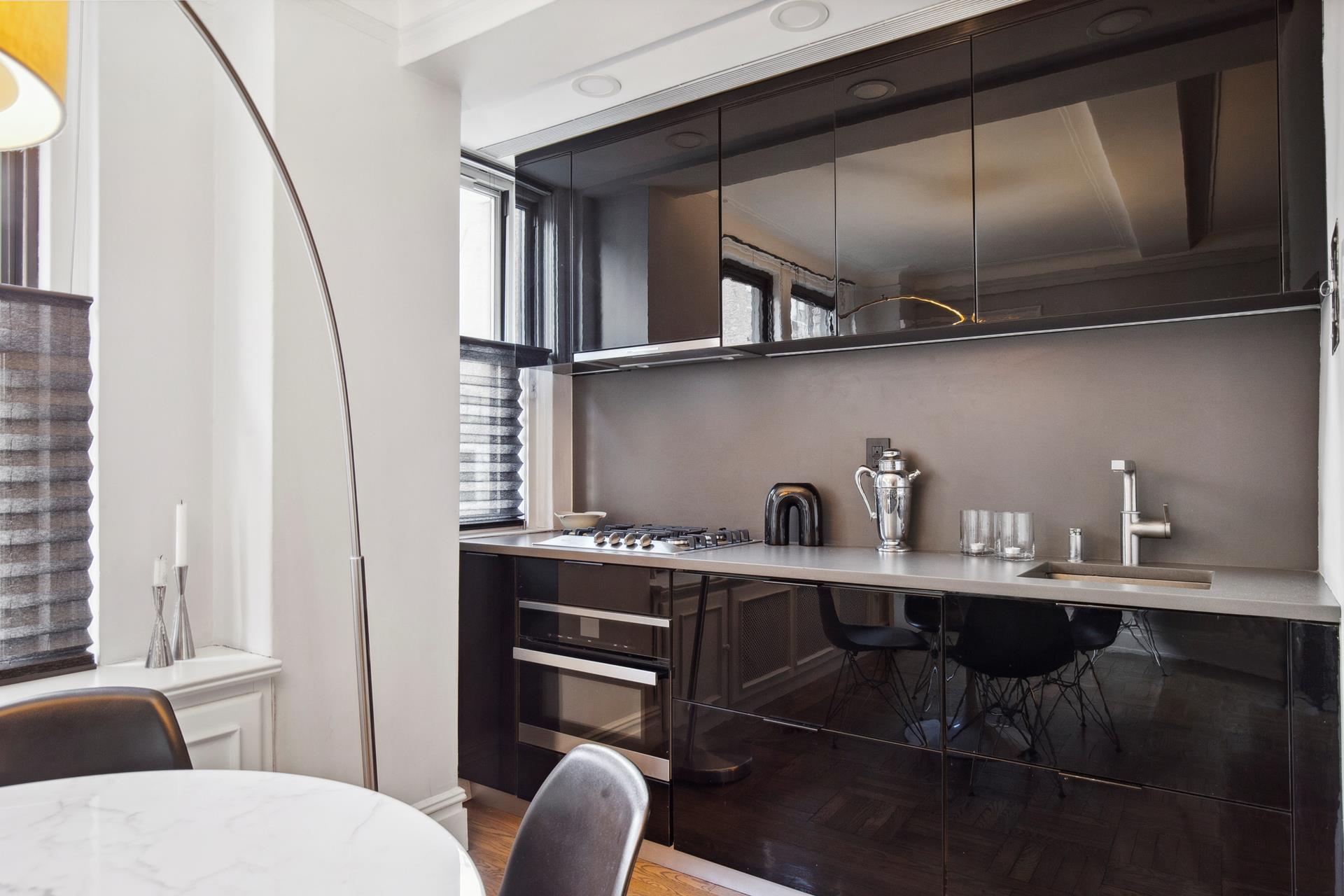 333 East 53rd Street, Unit 6B Manhattan, NY 10022 - Photo 5 of 15 a bathroom with a sink a stove and chairs