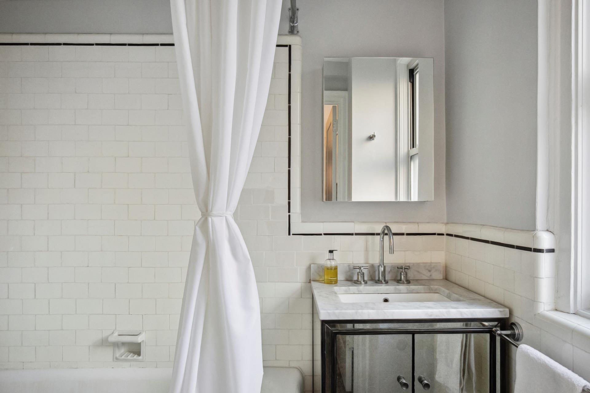 333 East 53rd Street, Unit 6B Manhattan, NY 10022 - Photo 6 of 15 a bathroom with a sink and a mirror