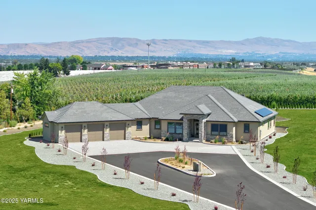 a aerial view of a house with swimming pool and a yard
