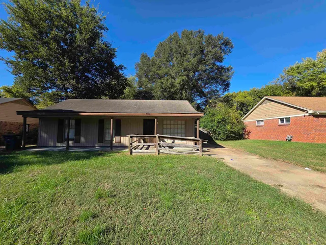 a view of a house with swimming pool and sitting area