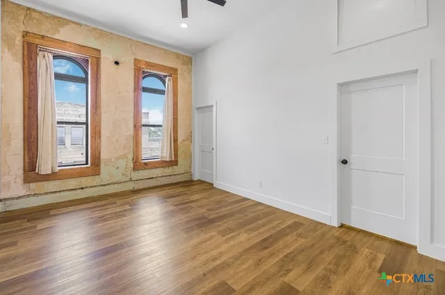 a view of walk in closet with empty racks