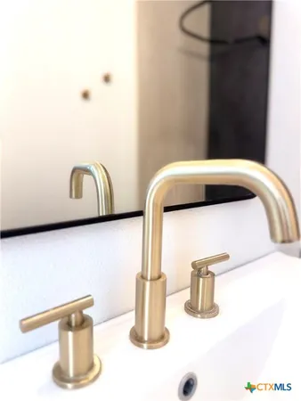 a kitchen with granite countertop a refrigerator stove and sink