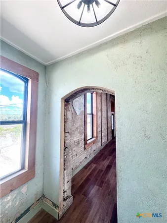 a view of a hardwood and utility room