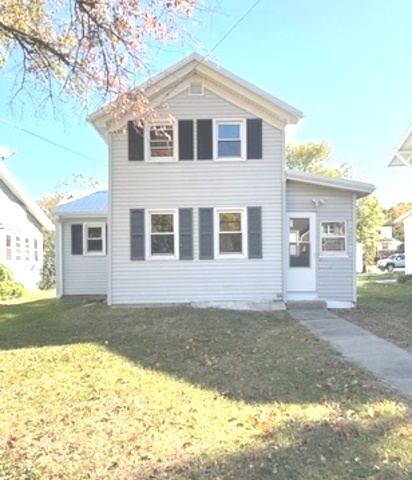 a front view of a house with a yard