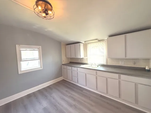 a kitchen with a sink cabinets and window