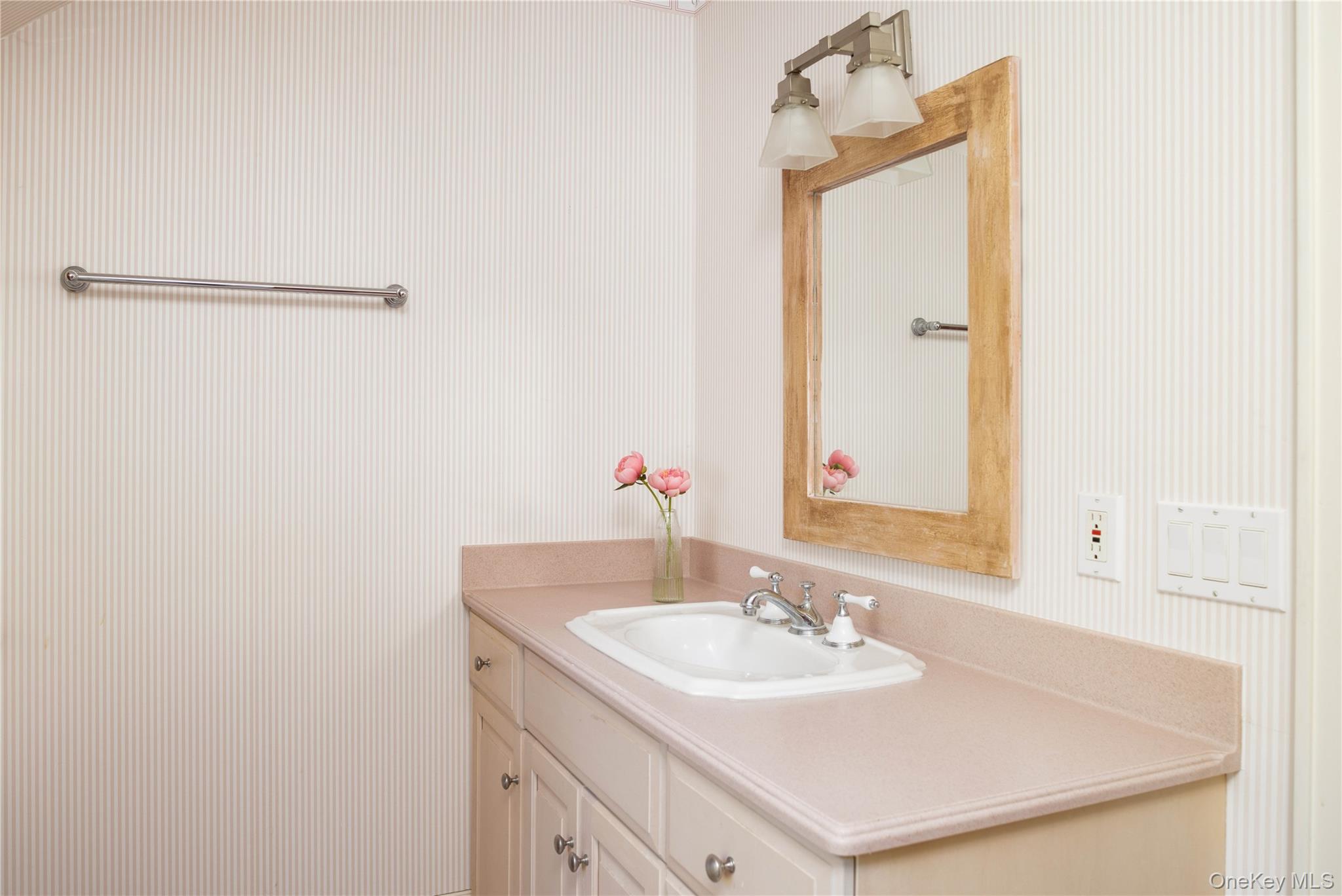 5055 New Suffolk Road New Suffolk, NY 11956 - Photo 27 of 42 a bathroom with a sink and a mirror