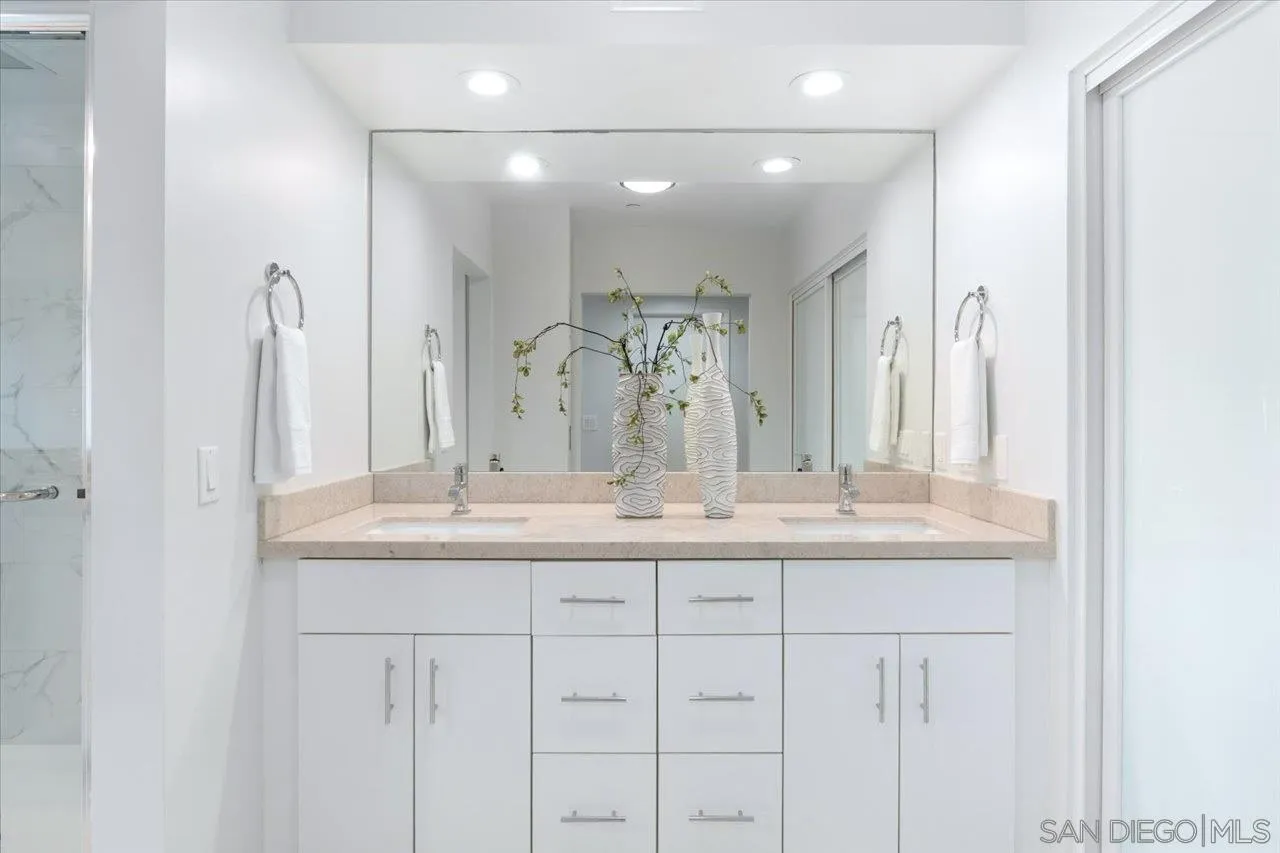 3161 1st Avenue, Unit 3S San Diego, CA 92103 - Photo 25 of 48 a bathroom with a granite countertop sink and a mirror