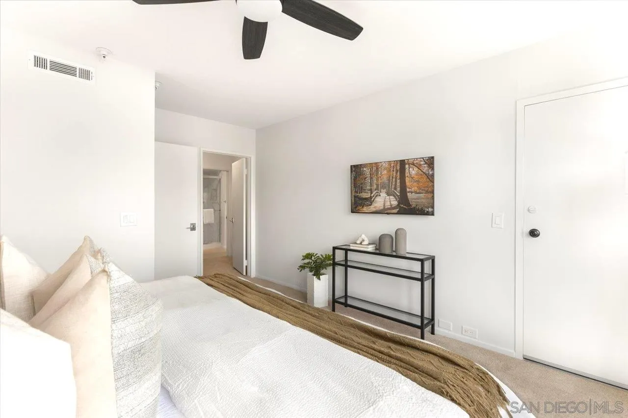 3161 1st Avenue, Unit 3S San Diego, CA 92103 - Photo 34 of 48 a bedroom with a bed and a chandelier