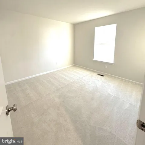 a view of an empty room and a window