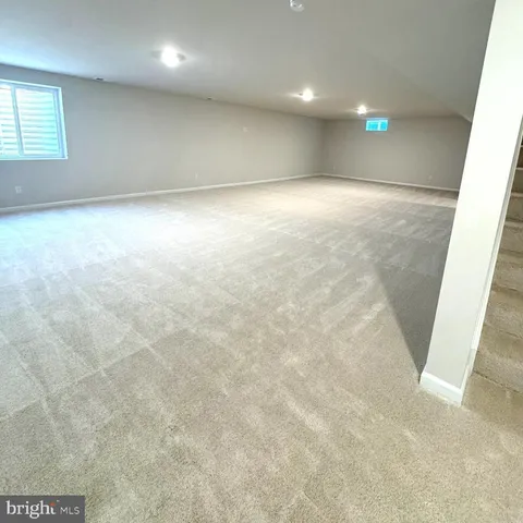 an empty room with windows and entrance