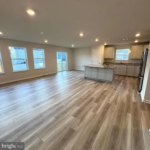 a view of kitchen with cabinets and wooden floor