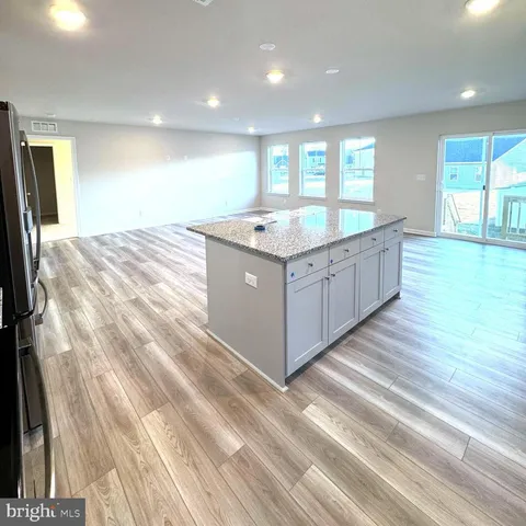 a kitchen with stainless steel appliances granite countertop a sink and a large window