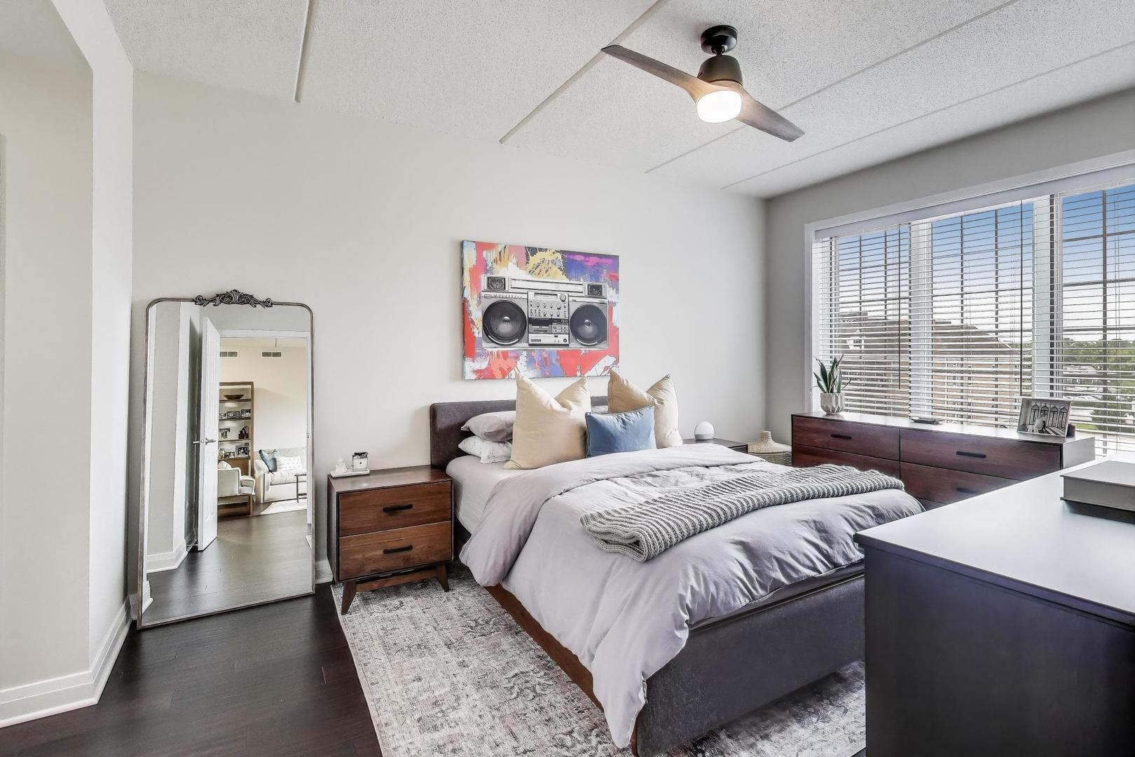 100 South Emerson Street, Unit 415 Mount Prospect, IL 60056 - Photo 7 of 15 a bedroom with two beds and a chandelier