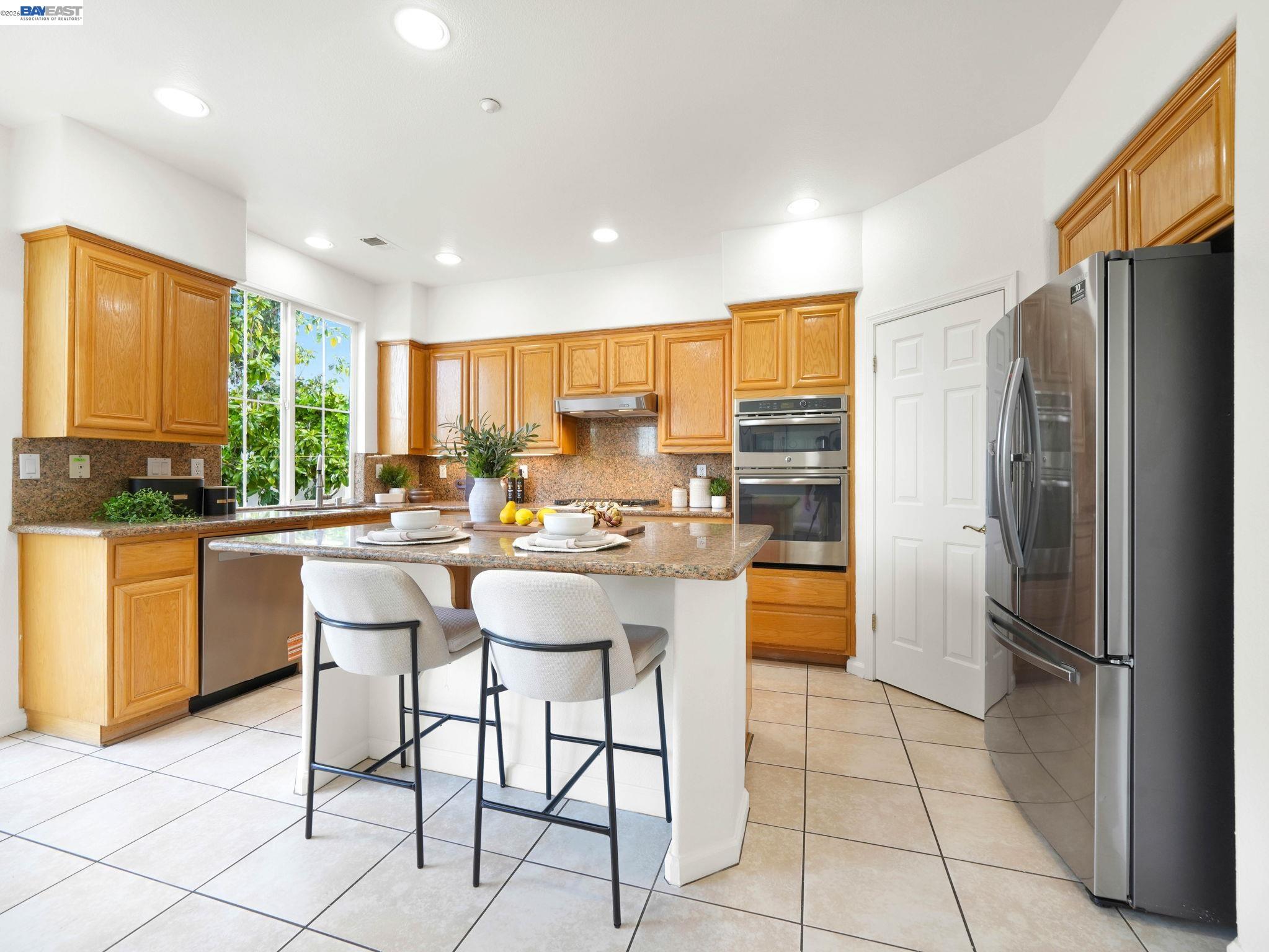 11 Meadows Court Fremont, CA 94539 - Photo 15 of 69 a kitchen with a refrigerator a counter top space and appliances