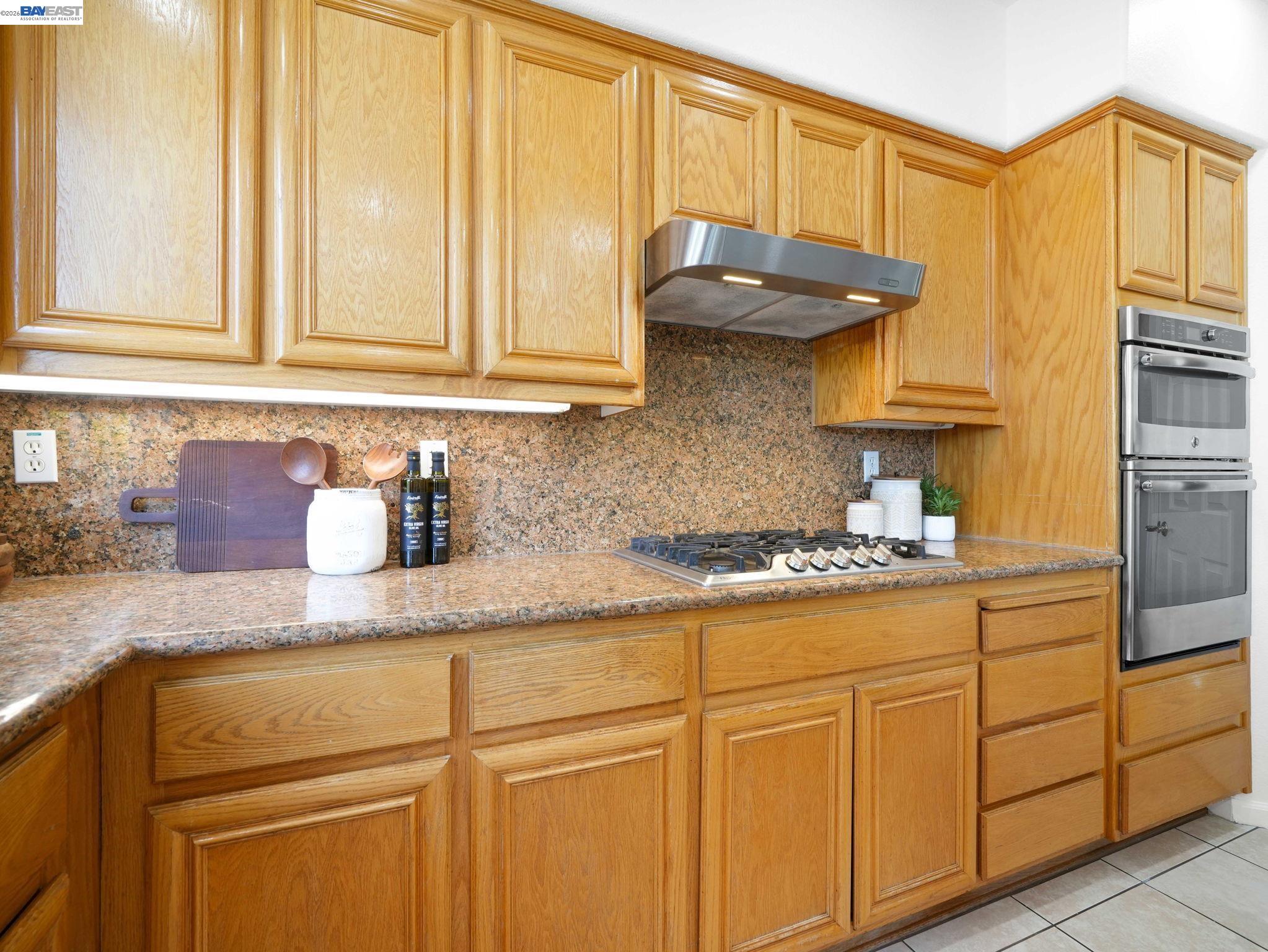 11 Meadows Court Fremont, CA 94539 - Photo 19 of 69 a kitchen with granite countertop stainless steel appliances a sink and cabinets