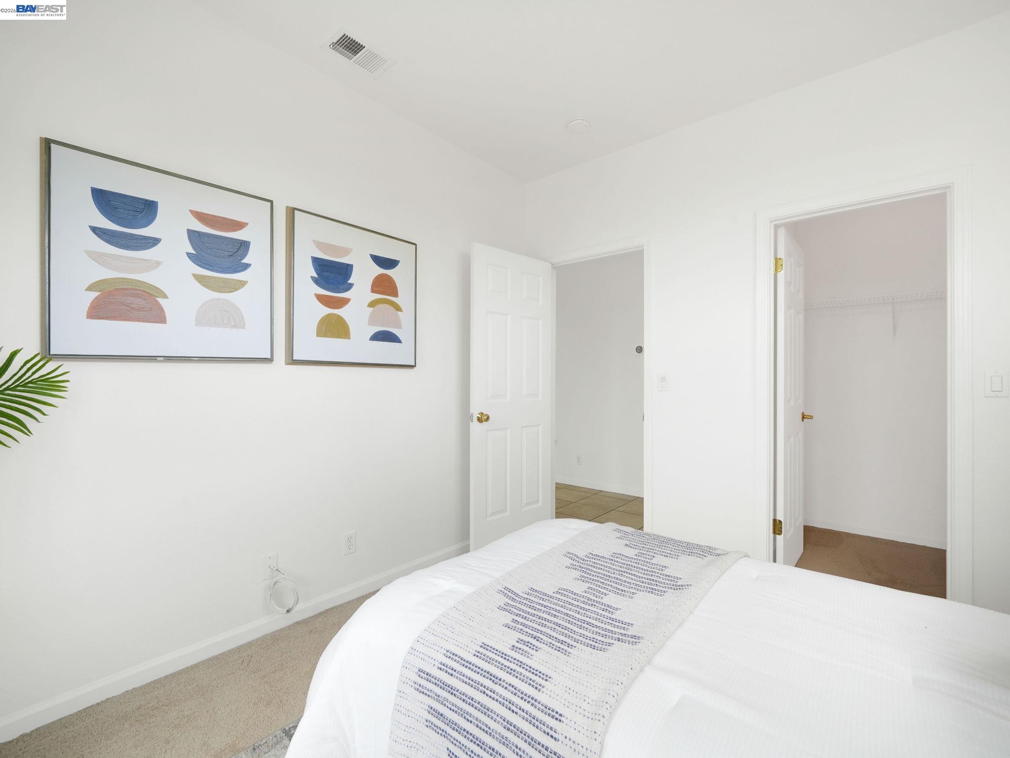11 Meadows Court Fremont, CA 94539 - Photo 21 of 69 a bedroom with a bed and painting on the wall