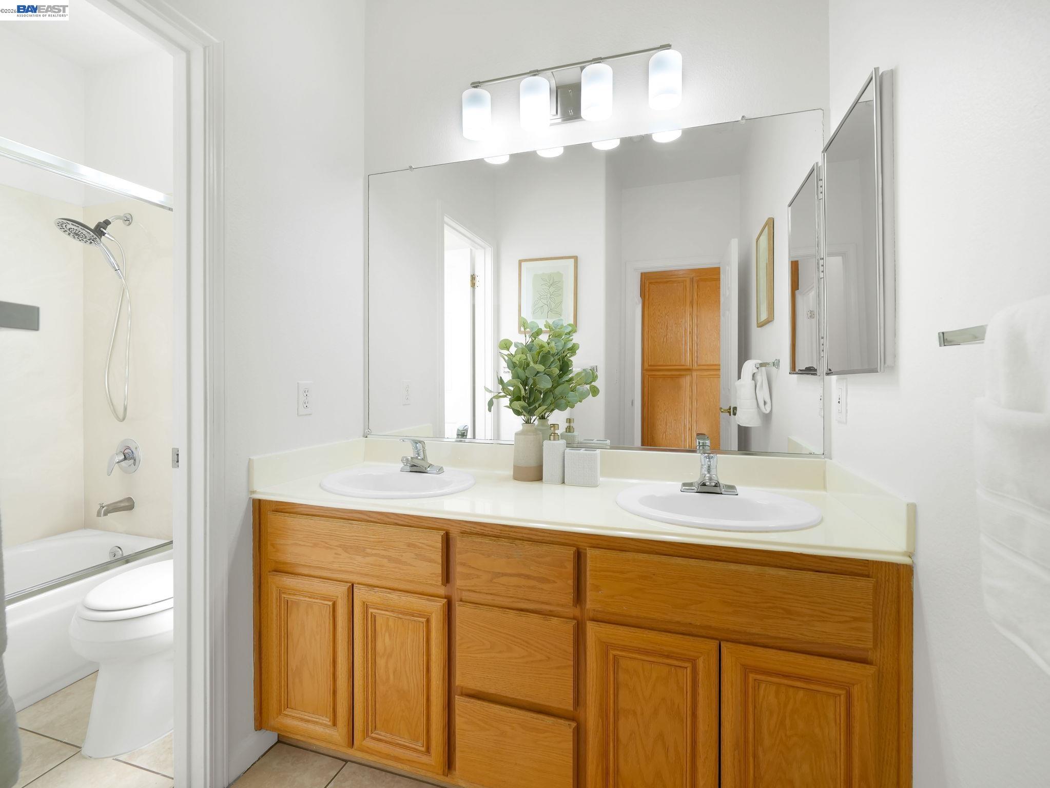11 Meadows Court Fremont, CA 94539 - Photo 35 of 69 a bathroom with a granite countertop sink a toilet and a large mirror