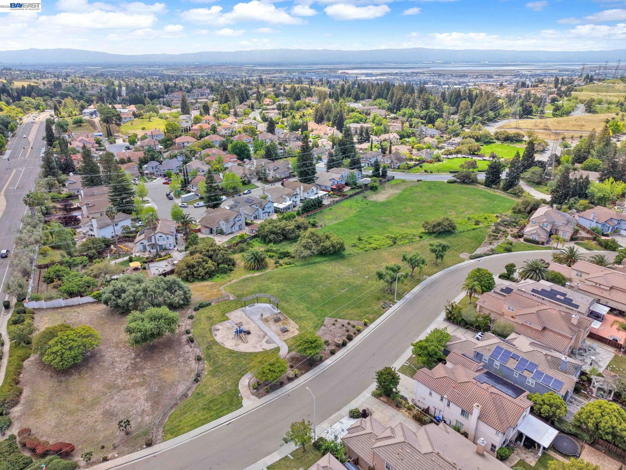 11 Meadows Court Fremont, CA 94539 - Photo 54 of 69 an aerial view of a city with lots of residential buildings ocean and mountain view in back