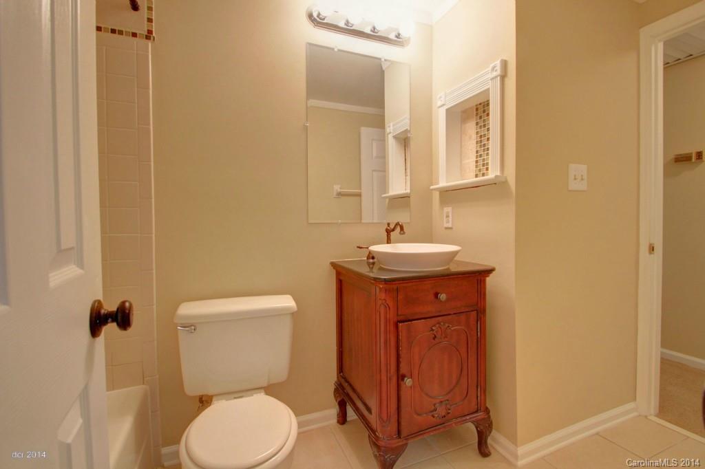 6625 Reddman Road Charlotte, NC 28212 - Photo 13 of 24 a bathroom with a toilet sink and mirror