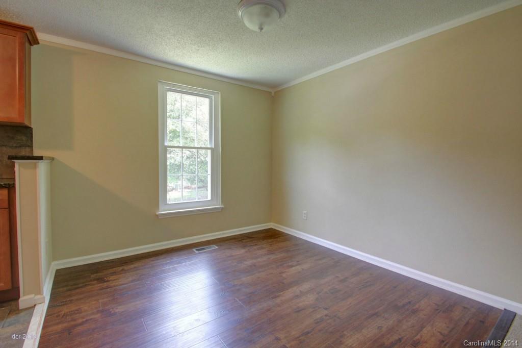 6625 Reddman Road Charlotte, NC 28212 - Photo 5 of 24 an empty room with wooden floor and windows