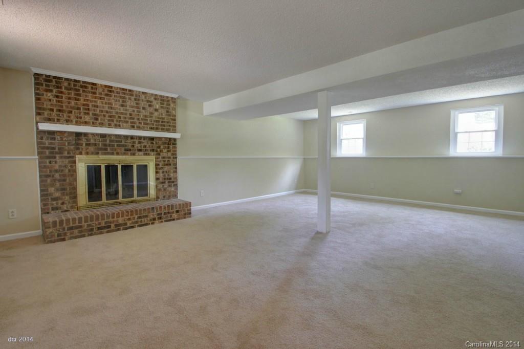 6625 Reddman Road Charlotte, NC 28212 - Photo 10 of 24 a view of an empty room with a fireplace and a window