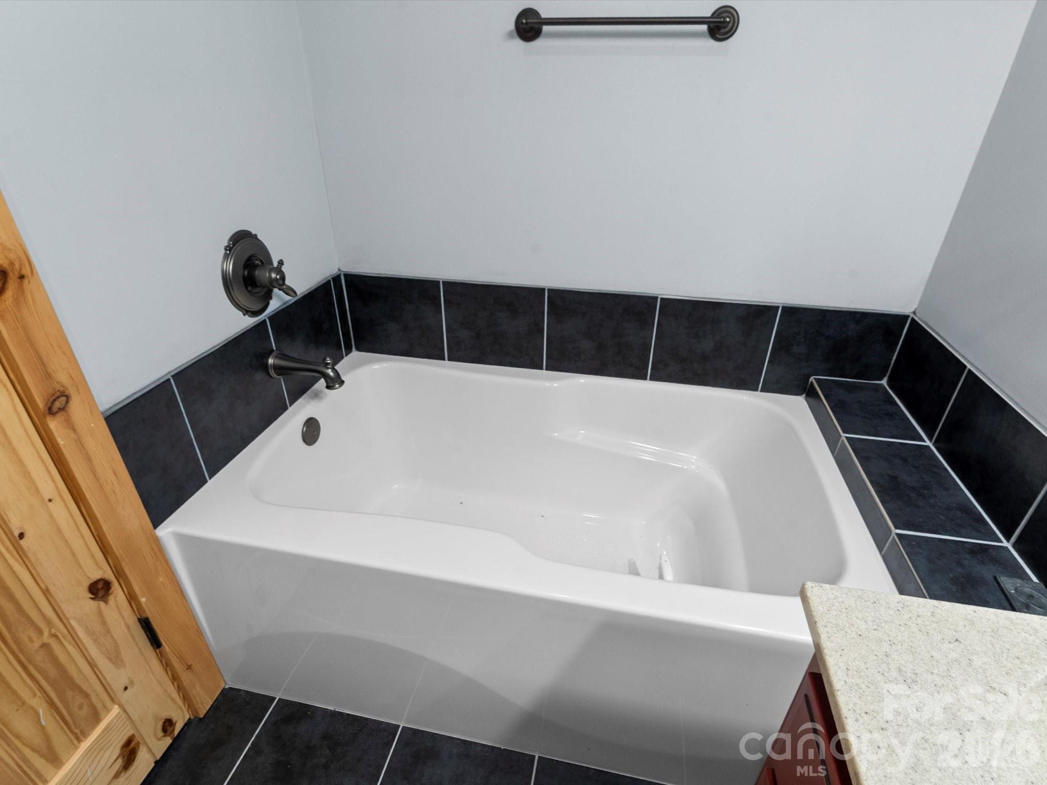 917 Otter Mountain Road Topton, NC 28781 - Photo 24 of 48 a bathroom with a tub