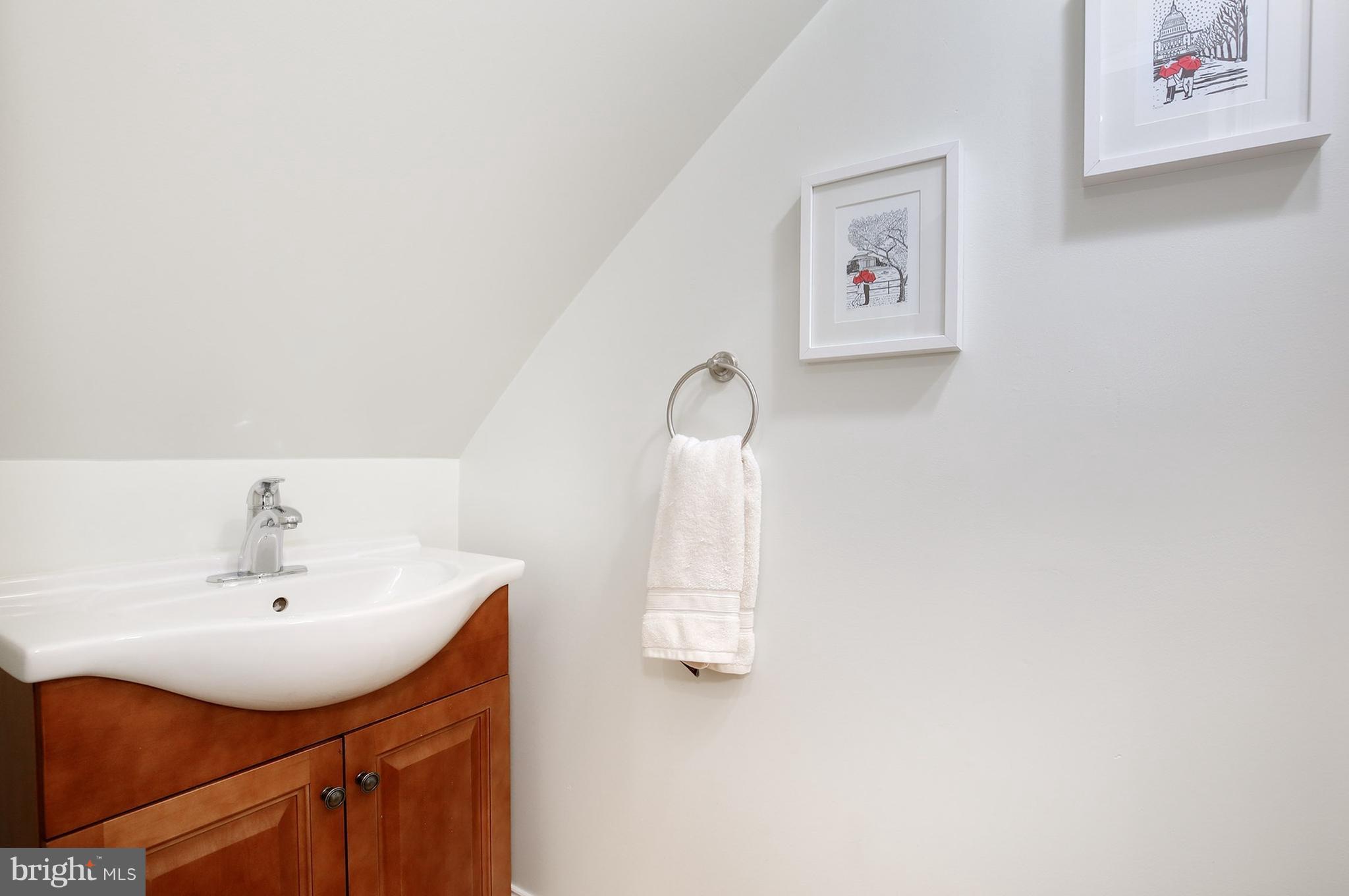 714 19th Street Northeast Washington, DC 20002 - Photo 17 of 27 a bathroom with a sink and a mirror
