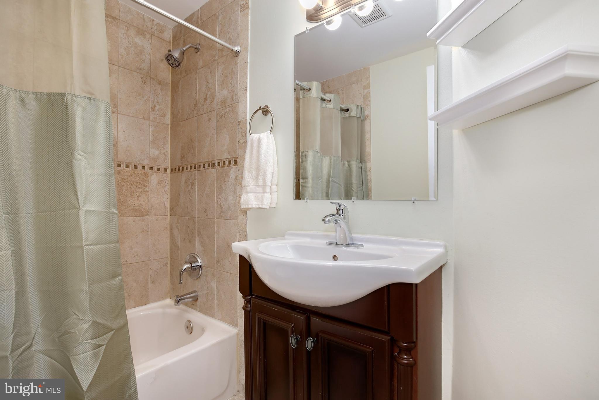 714 19th Street Northeast Washington, DC 20002 - Photo 22 of 27 a bathroom with a sink a toilet and shower