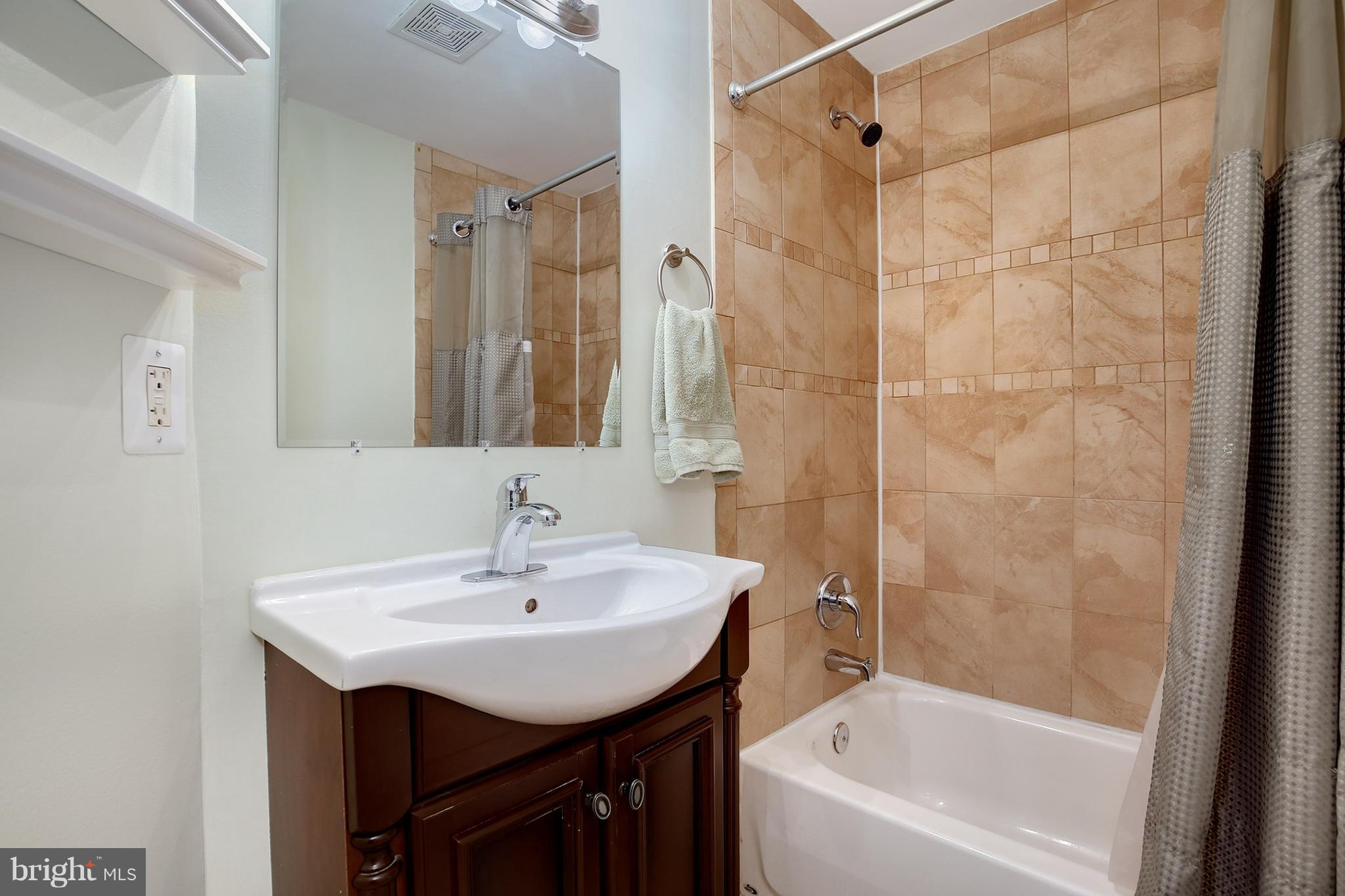 714 19th Street Northeast Washington, DC 20002 - Photo 26 of 27 a bathroom with a bathtub shower sink and a mirror