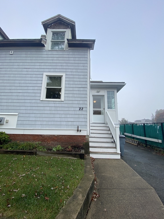 22 Harkins Street, Unit L Quincy, MA 02169 - Photo 2 of 15 a front view of a house with a garden