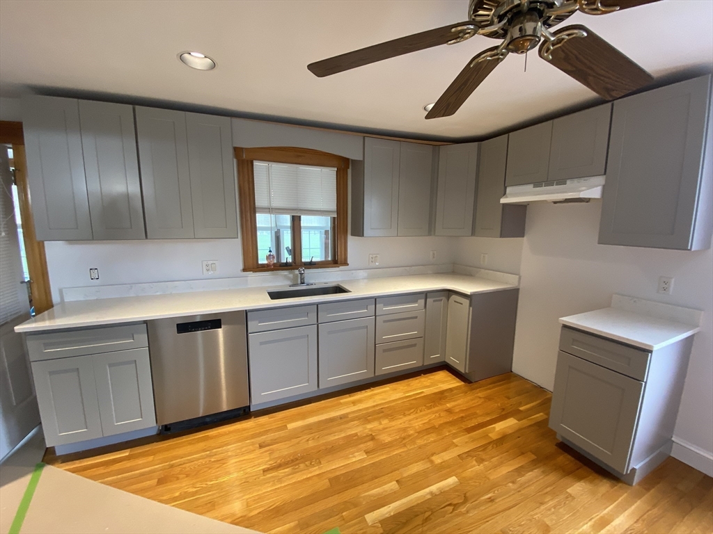 22 Harkins Street, Unit L Quincy, MA 02169 - Photo 3 of 15 a kitchen with a sink cabinets and wooden floor