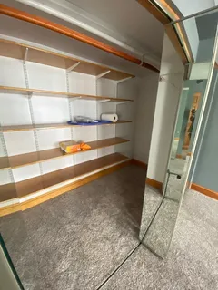 a view of walk in closet with empty racks