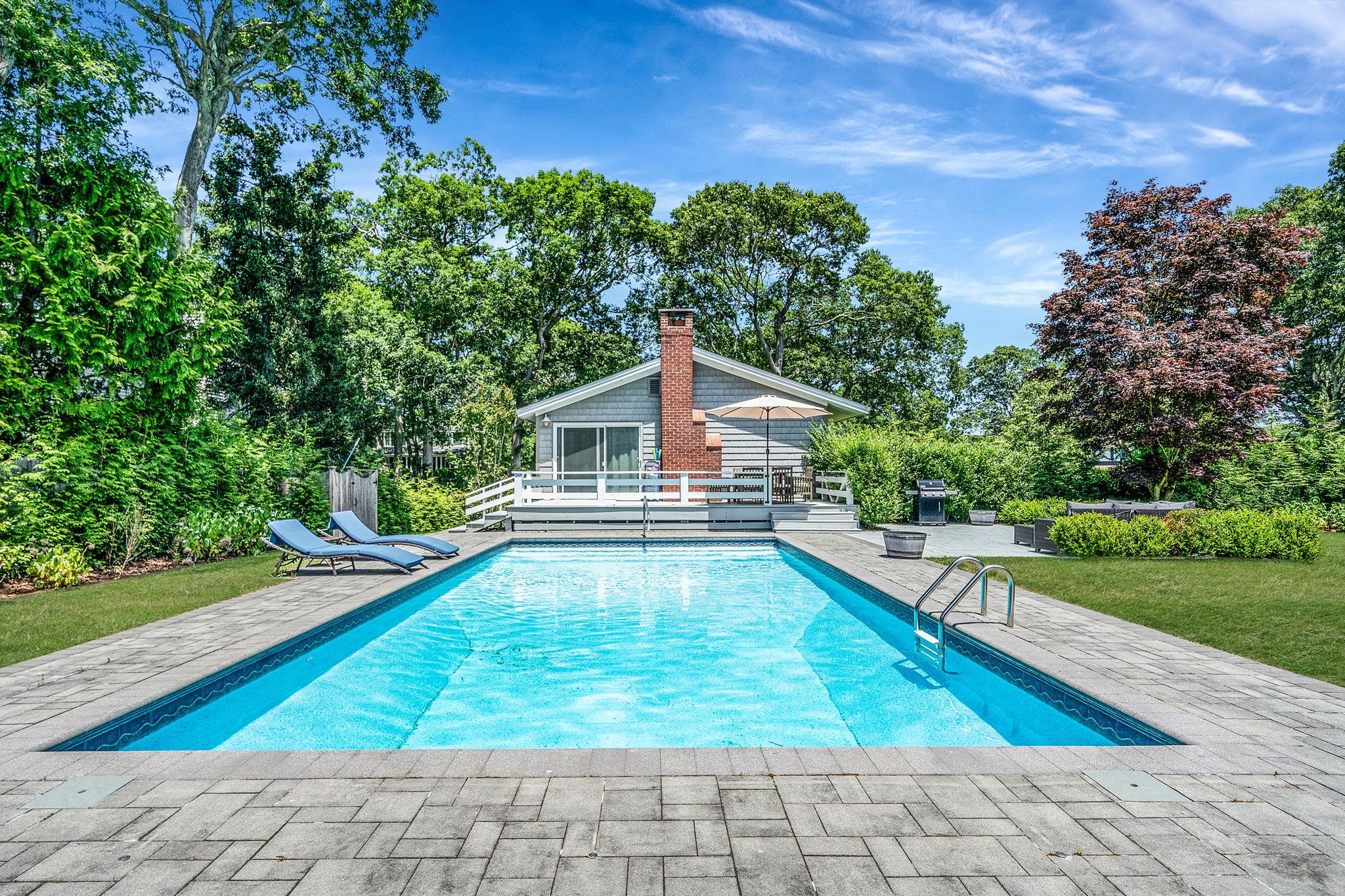 3 Crestview Drive Remsenburg, NY 11960 - Photo 17 of 21 Swimming pool with a patio, a yard, and view of scattered trees
