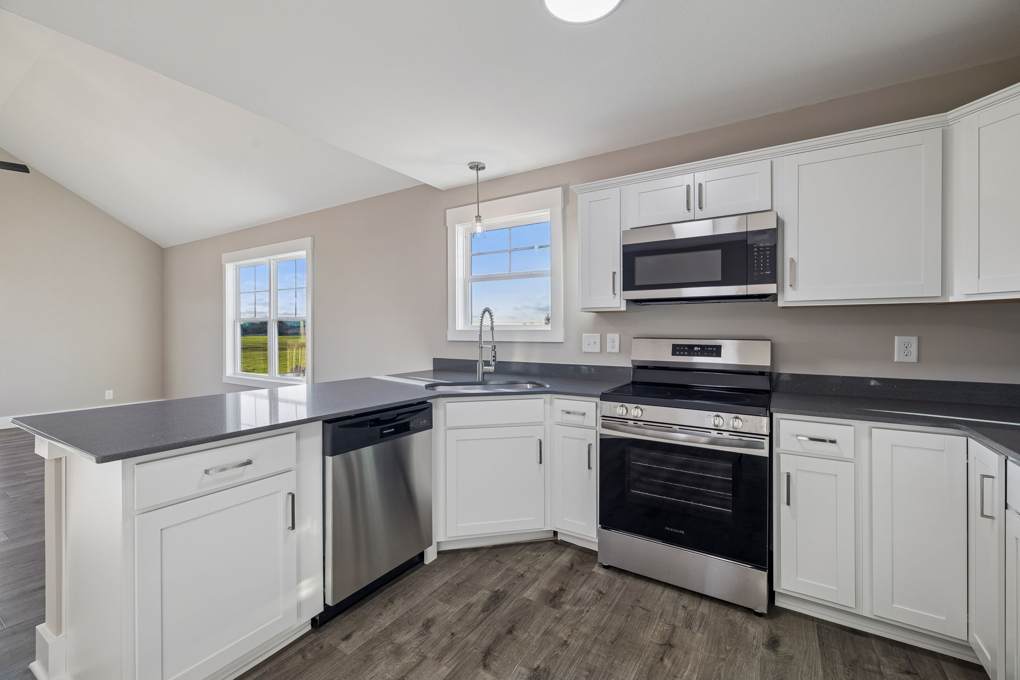 357 Hugh Hunter Road Oak Grove, KY 42262 - Photo 11 of 43 a kitchen with stainless steel appliances granite countertop a stove top oven a sink dishwasher and a microwave oven with cabinets