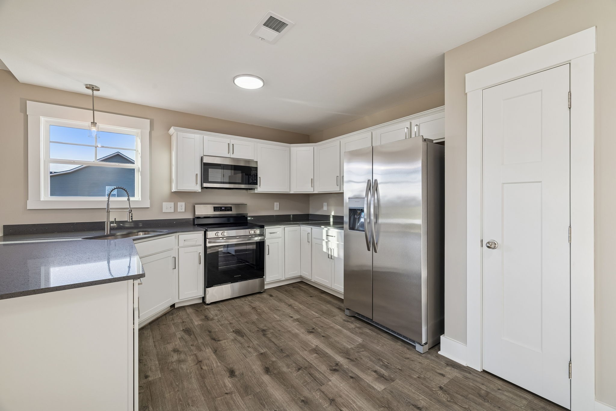 357 Hugh Hunter Road Oak Grove, KY 42262 - Photo 10 of 43 a kitchen with granite countertop a refrigerator stove and microwave