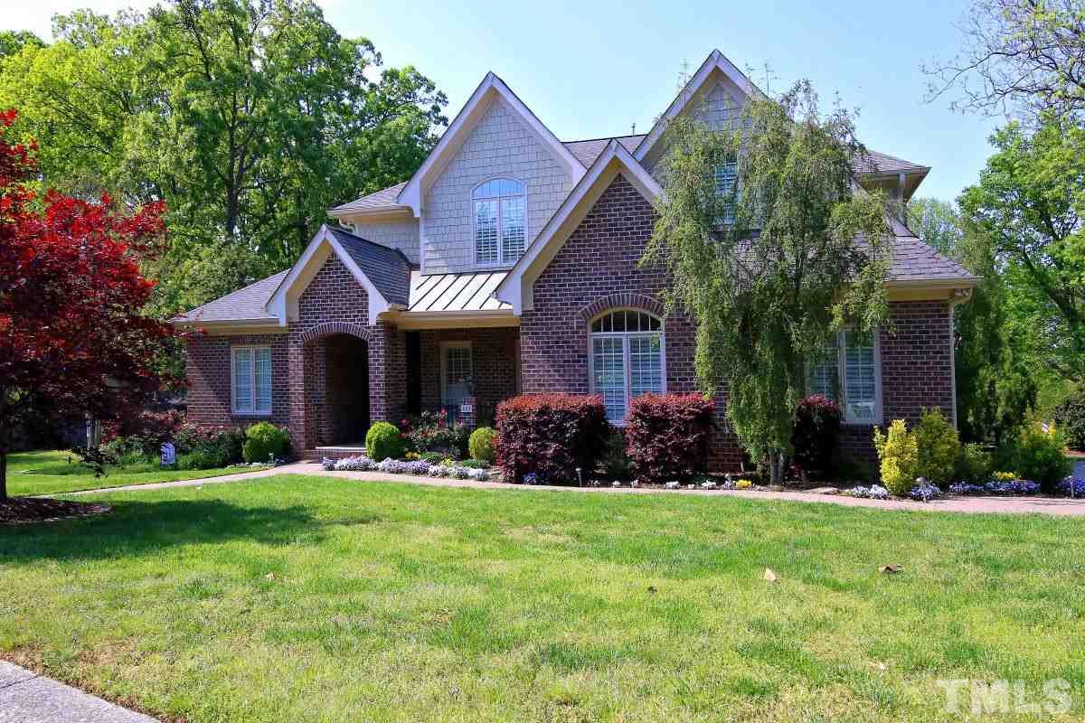 502 Shelley Road Raleigh, NC 27609 - Photo 1 of 25 a front view of a house with a yard and trees
