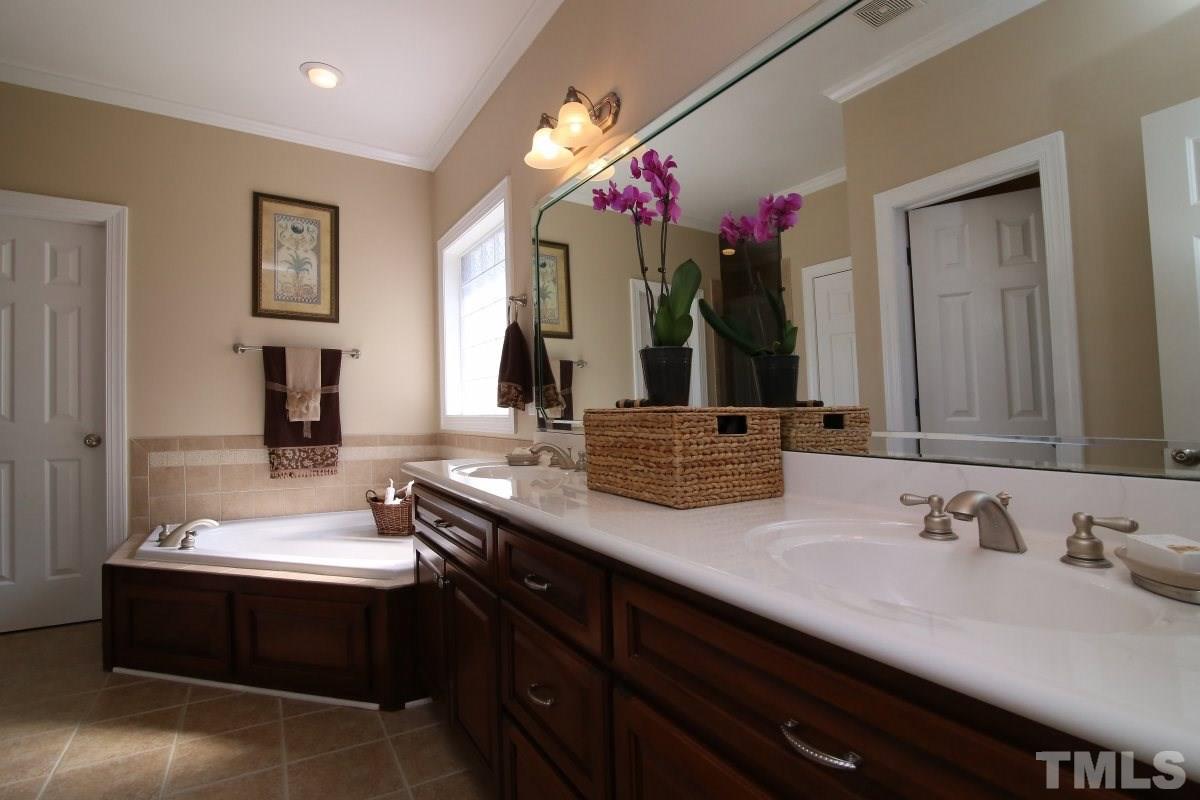502 Shelley Road Raleigh, NC 27609 - Photo 12 of 25 a bathroom with a sink double vanity and a mirror