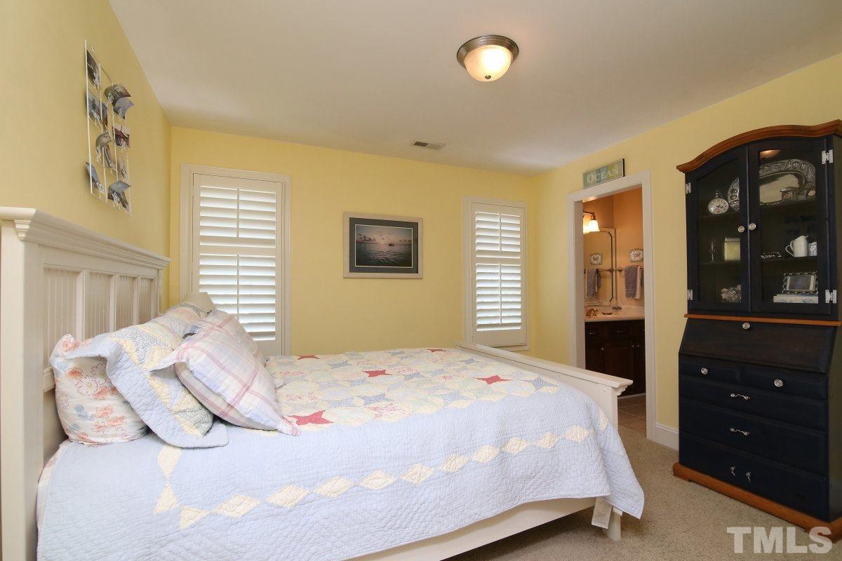 502 Shelley Road Raleigh, NC 27609 - Photo 17 of 25 a bedroom with a bed and a dresser