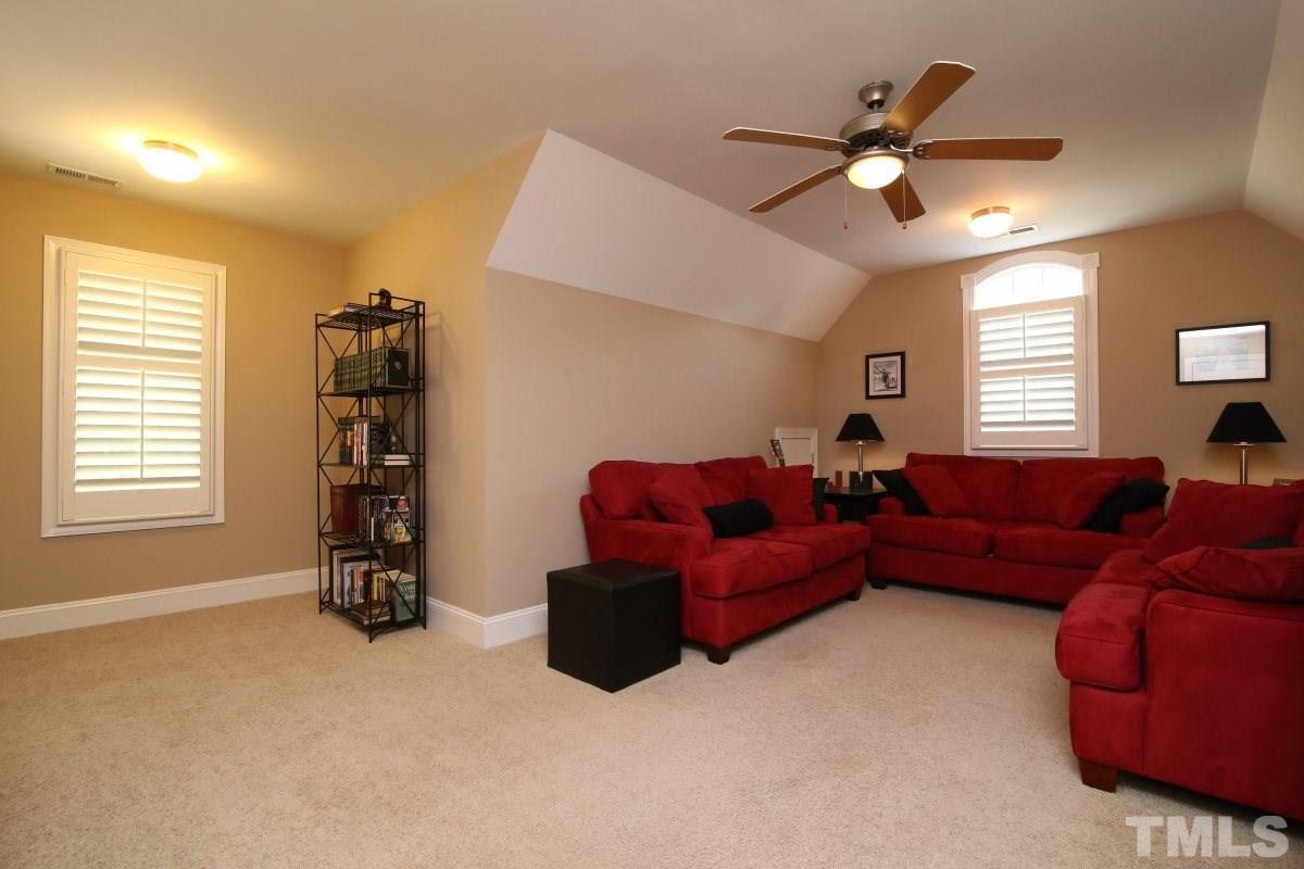 502 Shelley Road Raleigh, NC 27609 - Photo 19 of 25 a living room with furniture and a chandelier