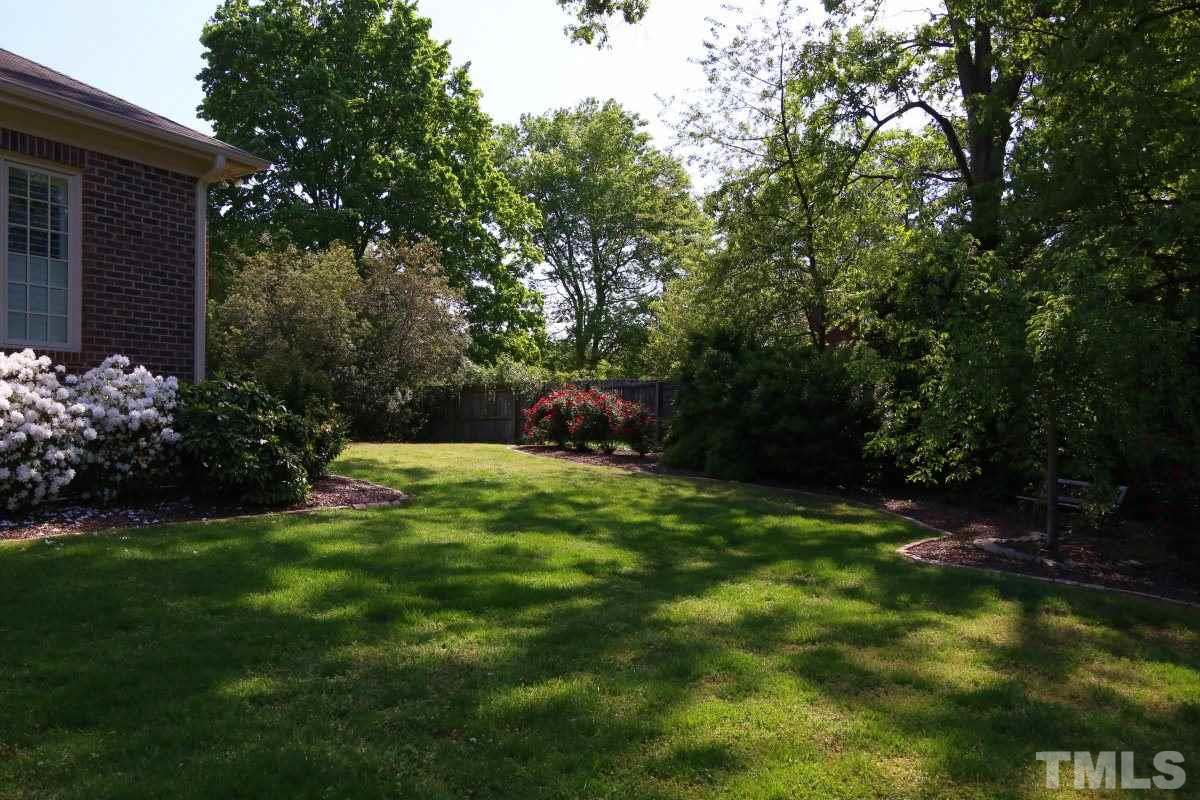 502 Shelley Road Raleigh, NC 27609 - Photo 23 of 25 a backyard of a house with lots of green space