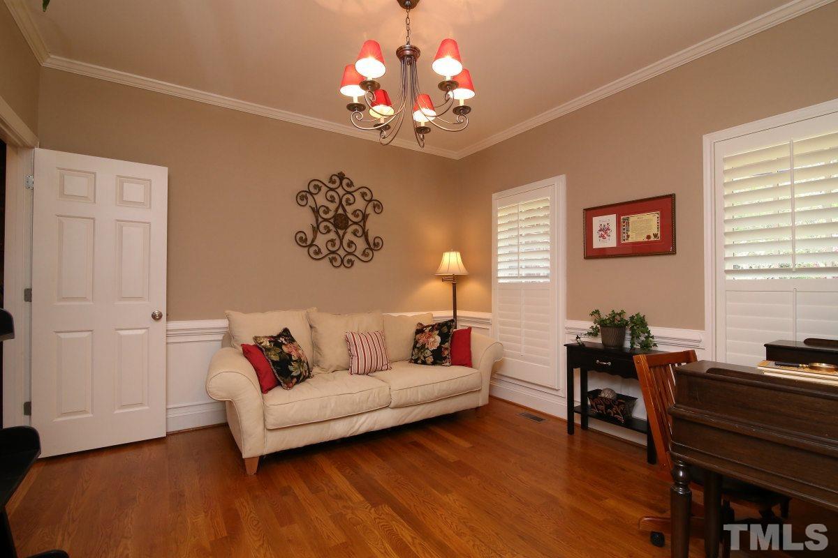 502 Shelley Road Raleigh, NC 27609 - Photo 5 of 25 a living room with furniture and a chandelier