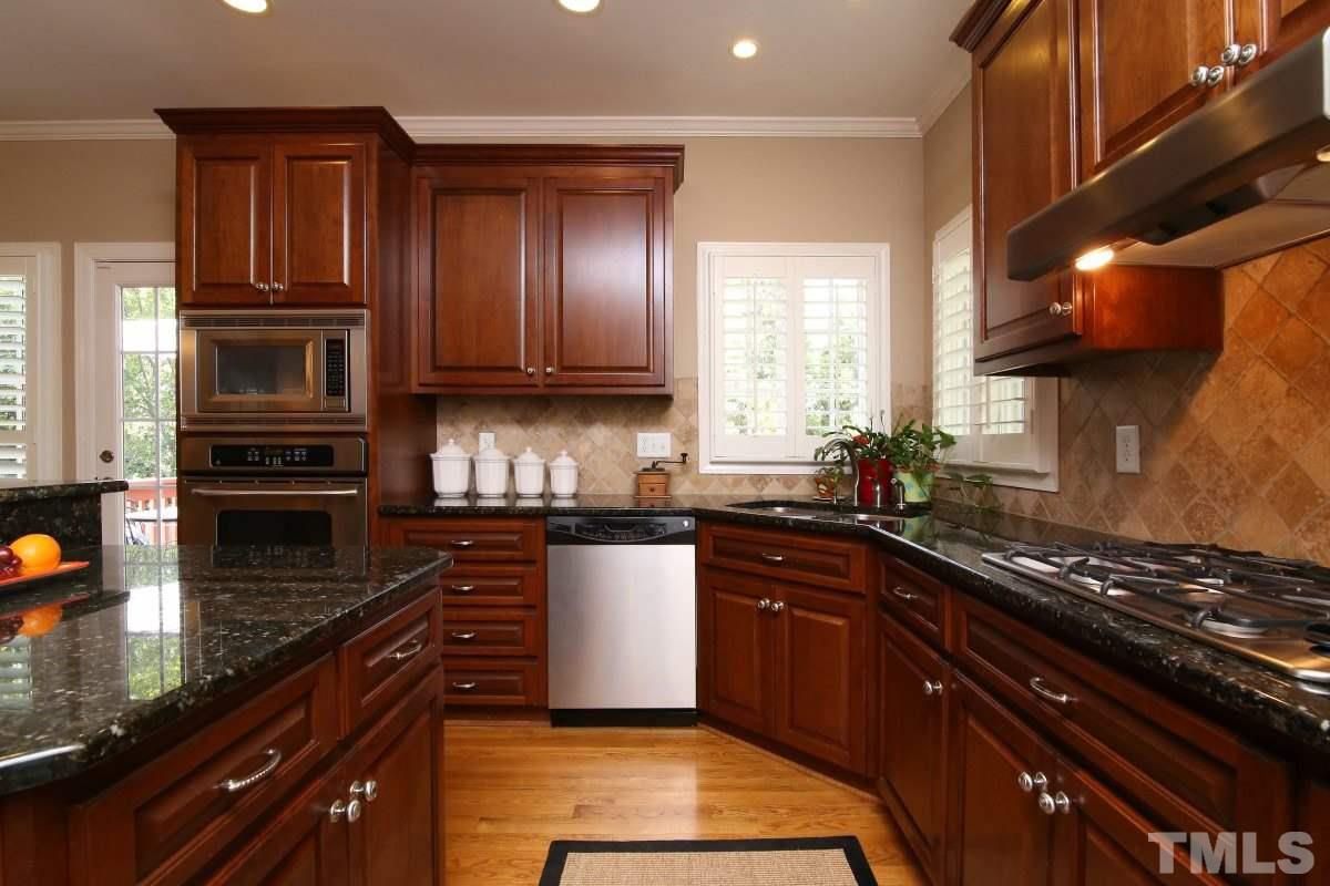 502 Shelley Road Raleigh, NC 27609 - Photo 10 of 25 a kitchen with stainless steel appliances granite countertop a stove a sink and a microwave