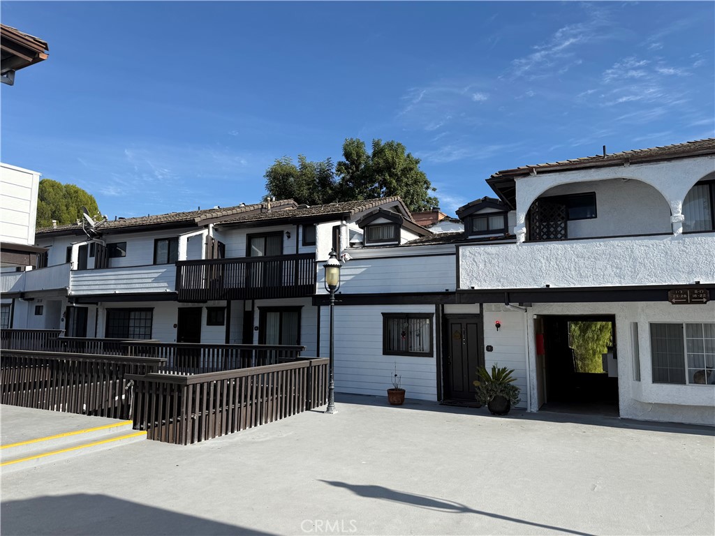 5250 Colodny Drive, Unit 21 Agoura Hills, CA 91301 - Photo 1 of 14 a front view of a house with a porch