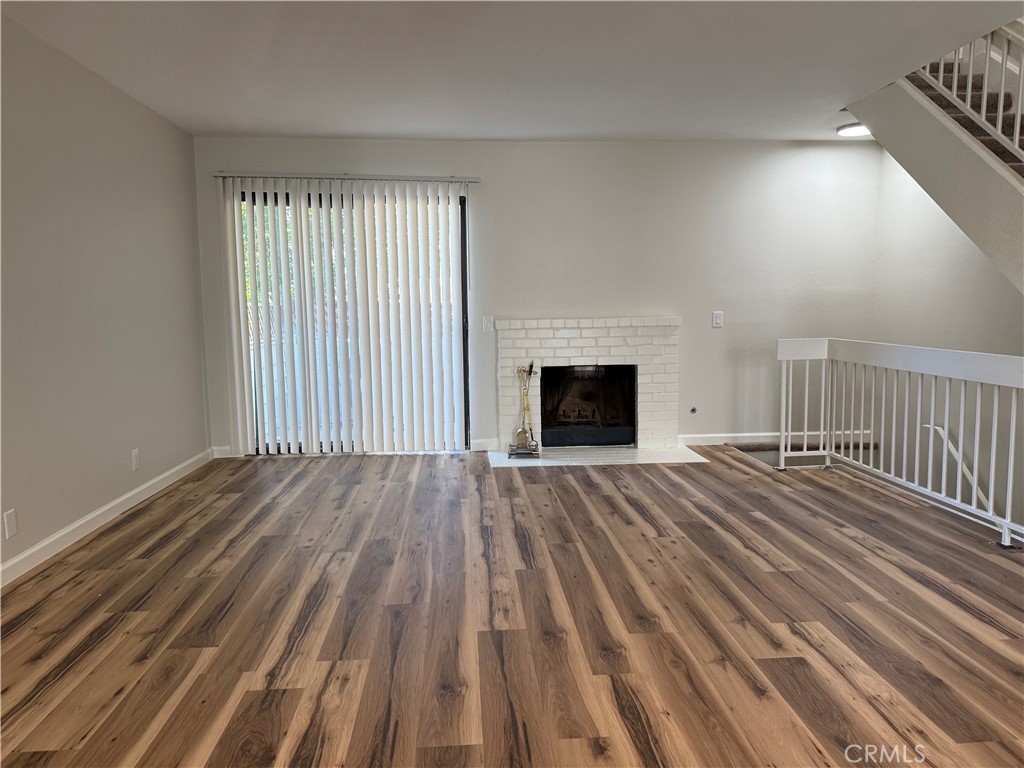 5250 Colodny Drive, Unit 21 Agoura Hills, CA 91301 - Photo 2 of 14 wooden floor fireplace and natural light in room