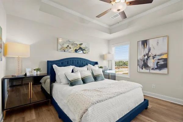 a bedroom with a large bed and a chandelier